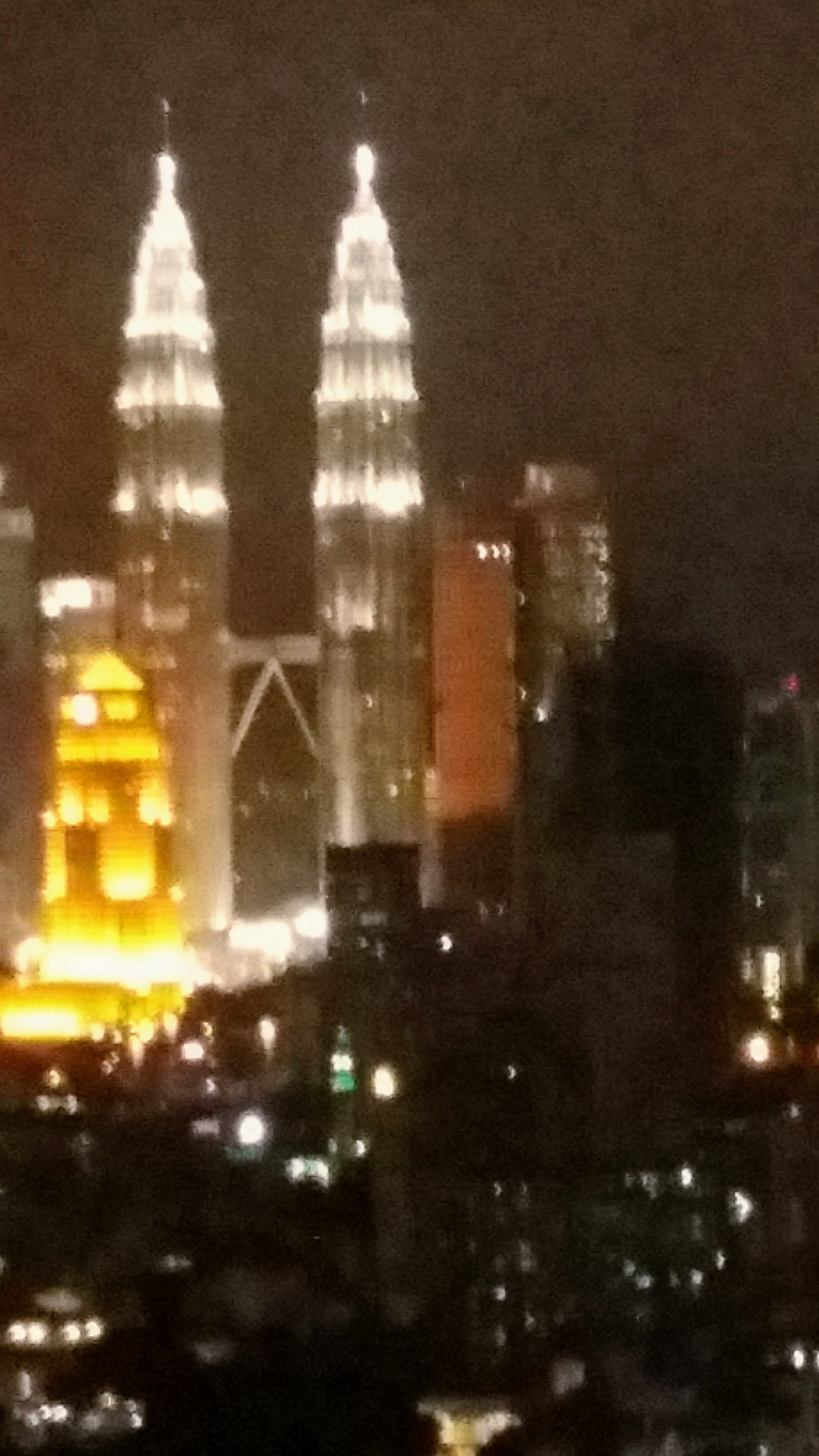 Petronas Towers, Kuala Lumpur, from hotel window at night, Malaysia 