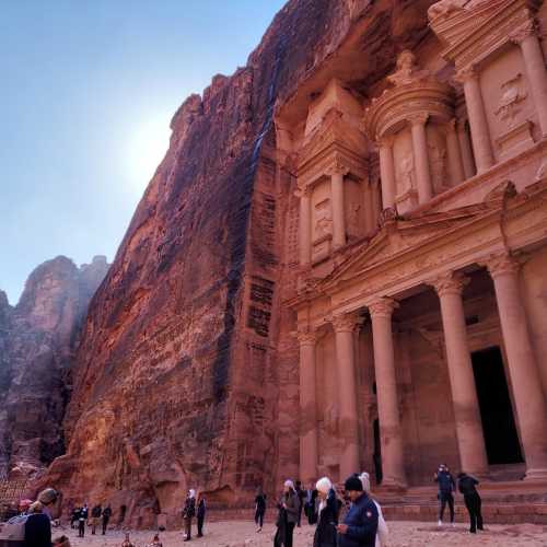 The Treasury — a temple carved into red sandstone cliffs by the ancient Nabataen Kingdom in the Jordanian desert, in Petra, Jordan