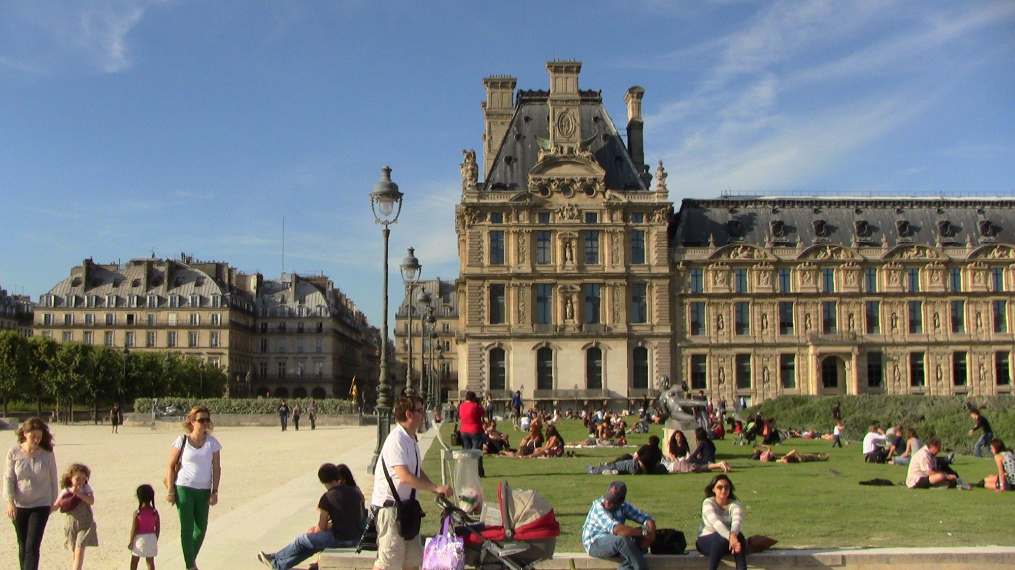 Louvre Palace and Museum where leisurely Parisians enjoy the formal gardens, in the center of Paris, France