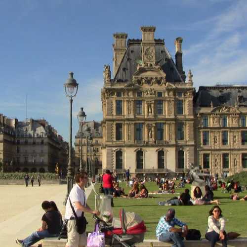 Louvre Palace and Museum where leisurely Parisians enjoy the formal gardens, in the center of Paris, France