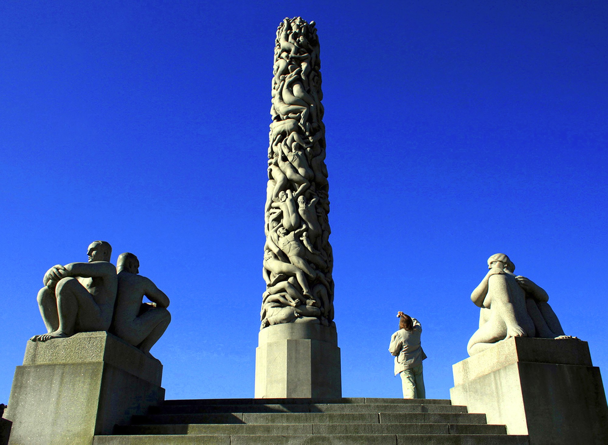 The tourist photographs a column in park of sculptures of Vigelanna