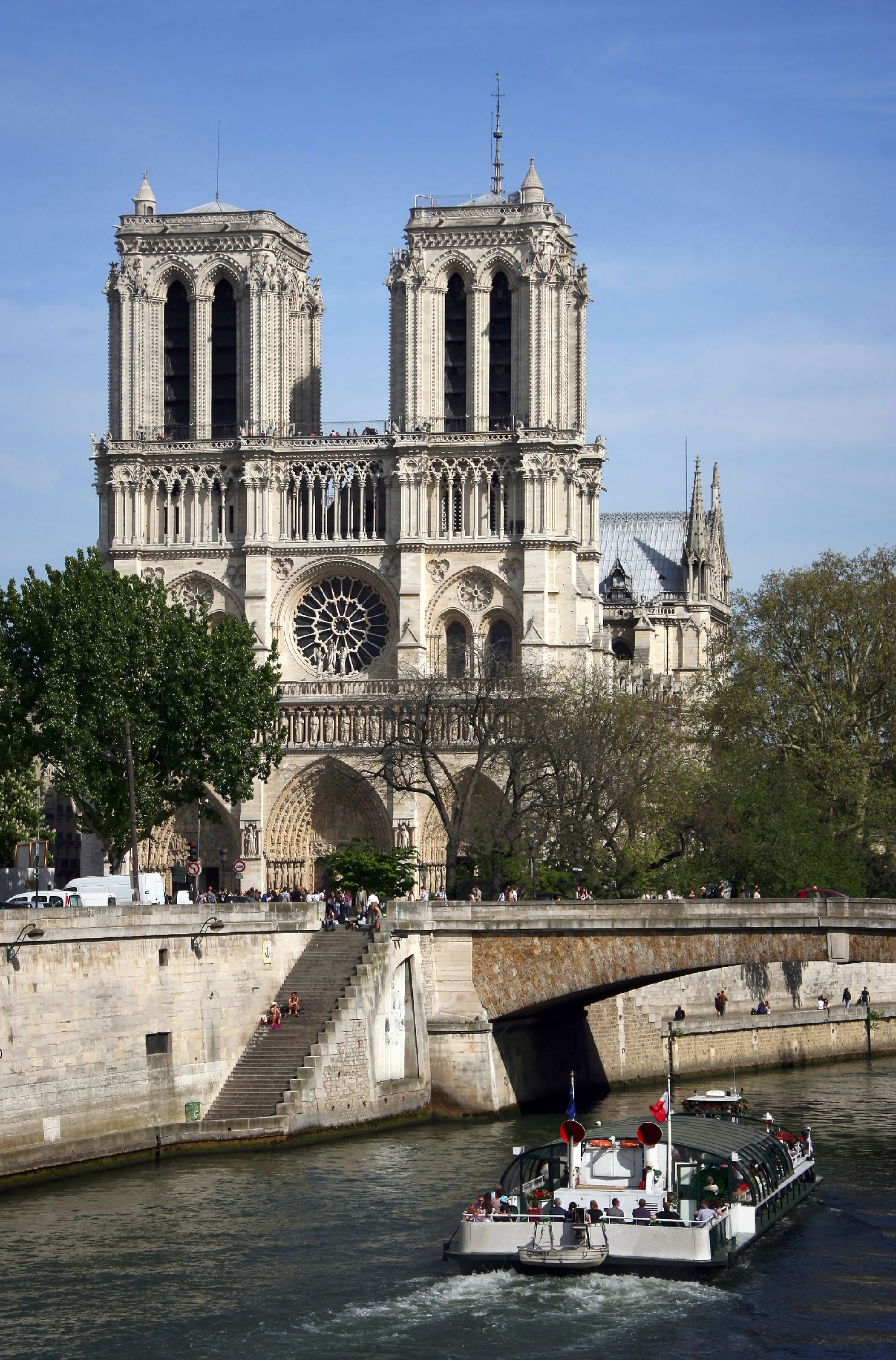 Pleasure boat floating on the river Seine in the background of the Notre Dame de Paris