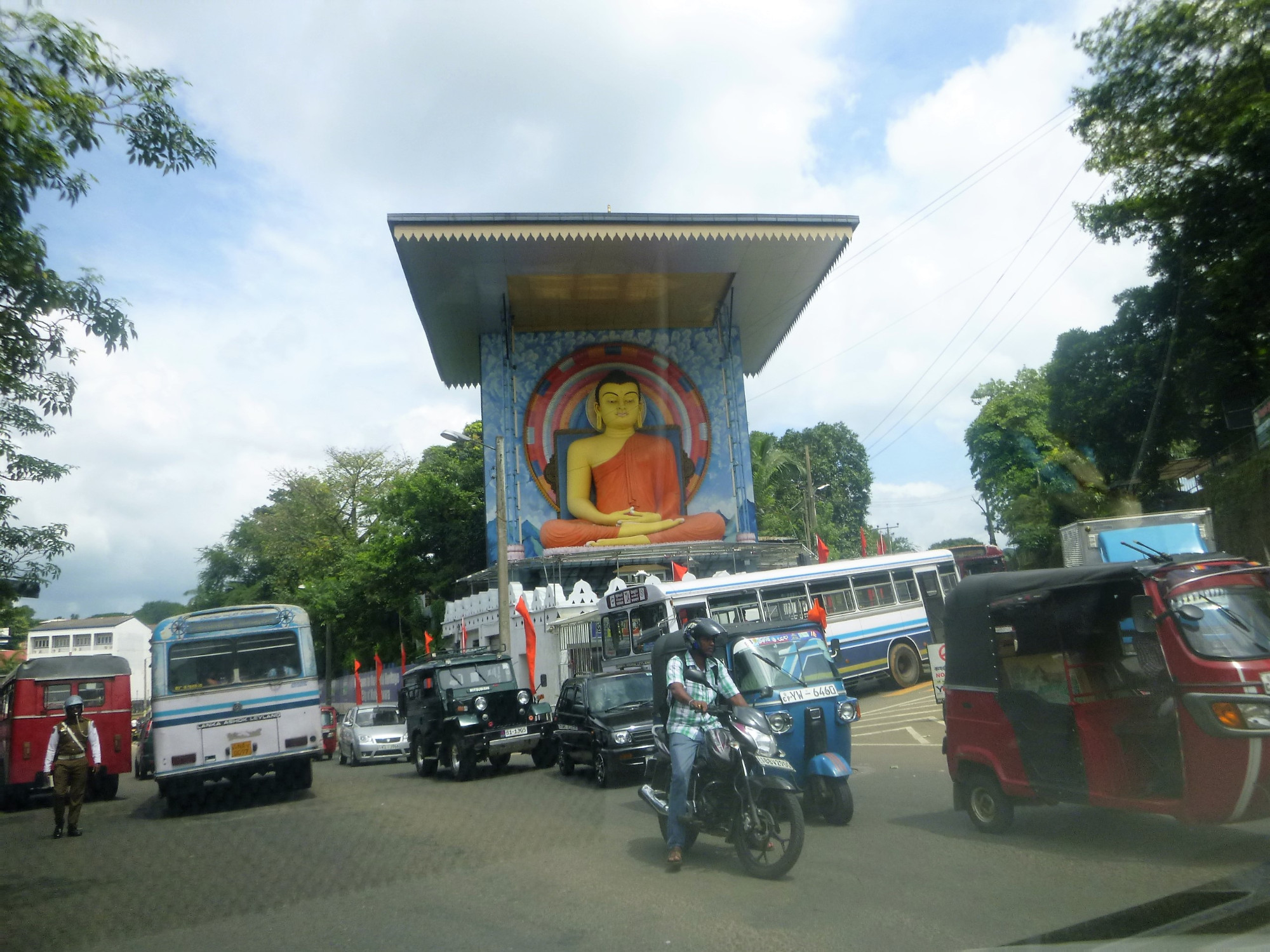 Statue of sitting meditating Buddha on the main road 