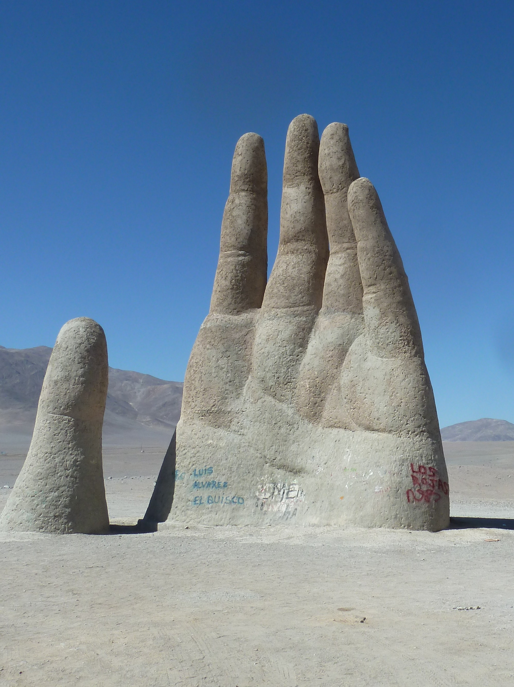 36-ft. sculpture by a Chilean artist shaped like a raised hand coming out of the deser