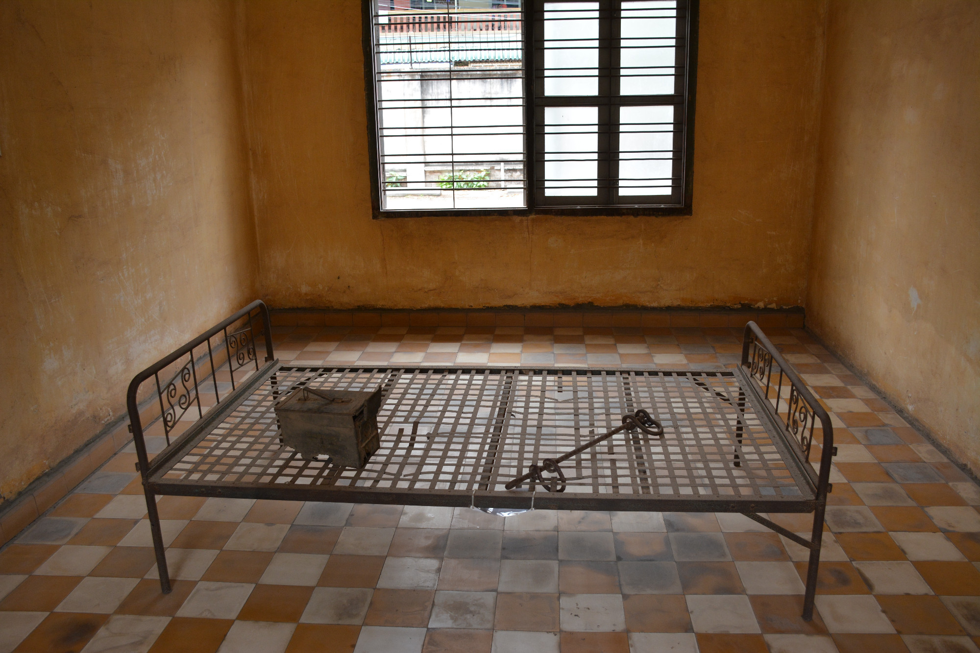 Cell prisoner chained to bed frame