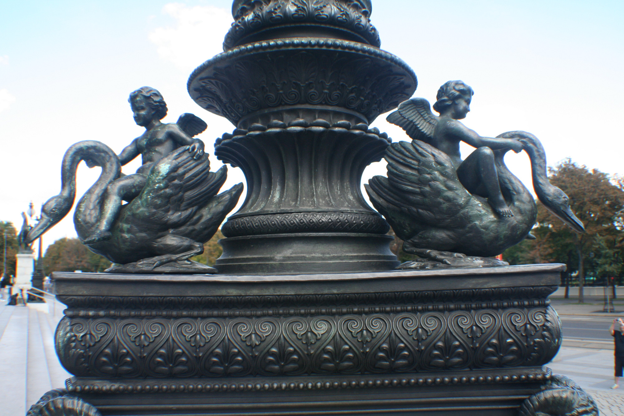 A lamppost decorated with swan and cherub sculptures outside Parliament <br/>

