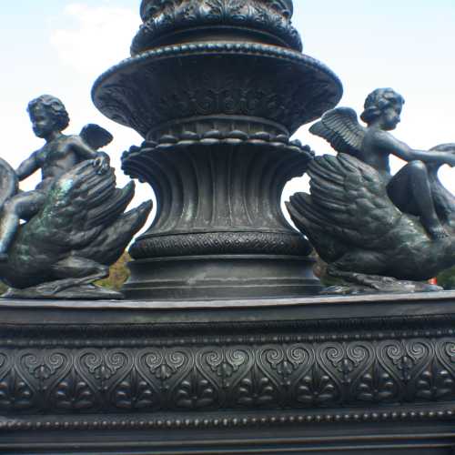 A lamppost decorated with swan and cherub sculptures outside Parliament <br/>
