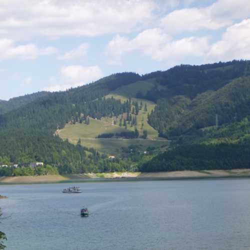 Large reservoir, dam & seasonal recreation area surrounded by a scenic mountain landscape.